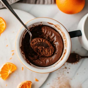 A single ramekin of chocolate orange baked oats with a melting piece of chocolate on top.