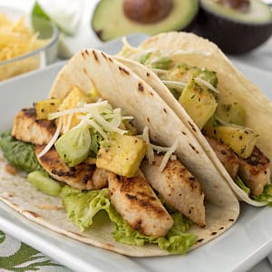 Easy homemade pineapple chicken tacos with avocado and cilantro